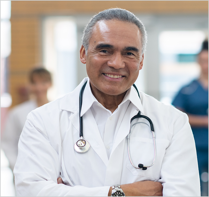 Physician smiles in a hospital.