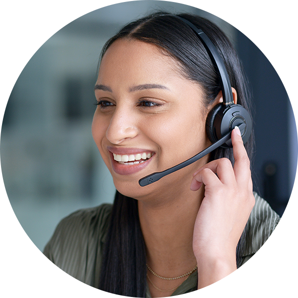 Female young professional smiling and talking on headset.