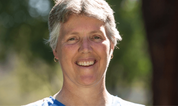 Close up of woman smiling outdoors.