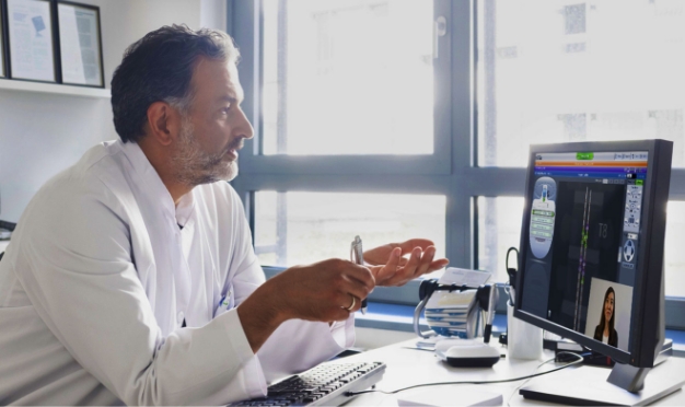 Male doctor talking during online meeting.