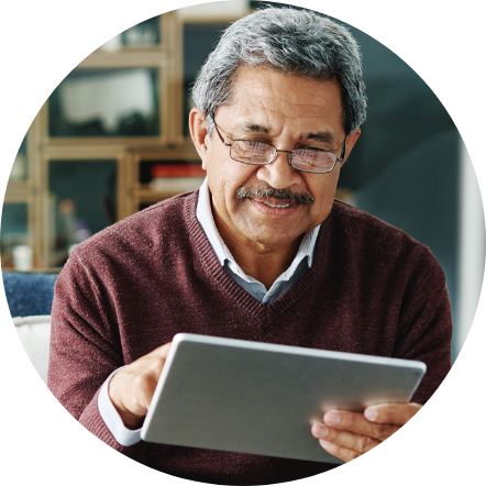 Senior man interacting with a tablet device.