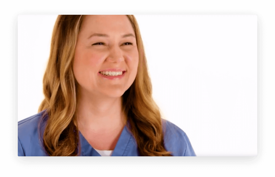 Woman in blue scrubs smiling.