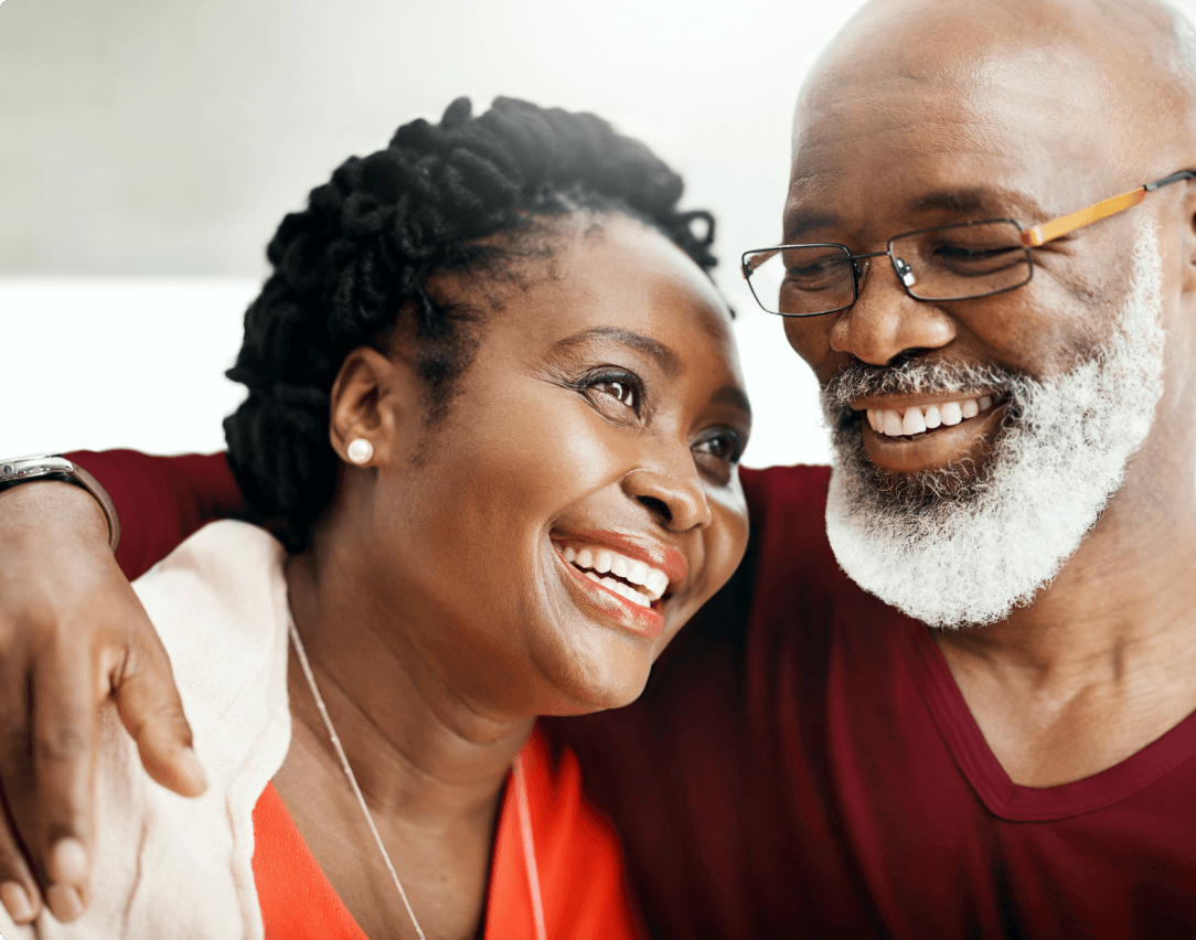 Man with his arm around a woman.