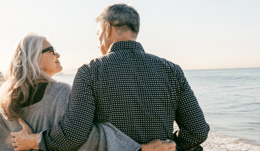 Man with his arm around a woman.