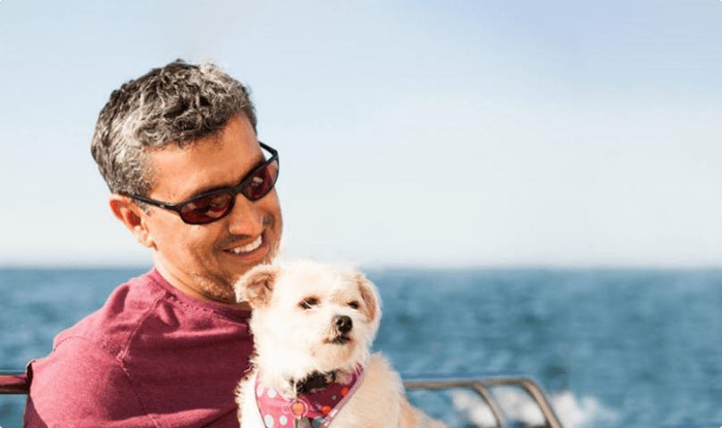 A man sitting with his dog.