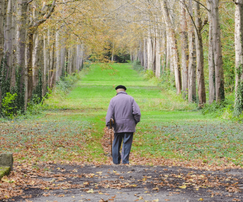 Spinal Cord Stimulation patient Harold walking through a field.