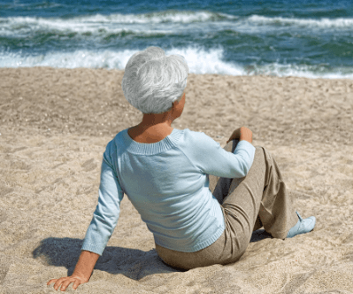 Vertiflex Procedure patient Donna sitting on a beach.