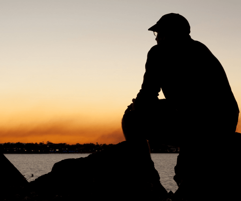 Spinal Cord Stimulation patient Edward watching the sunset at the beach.