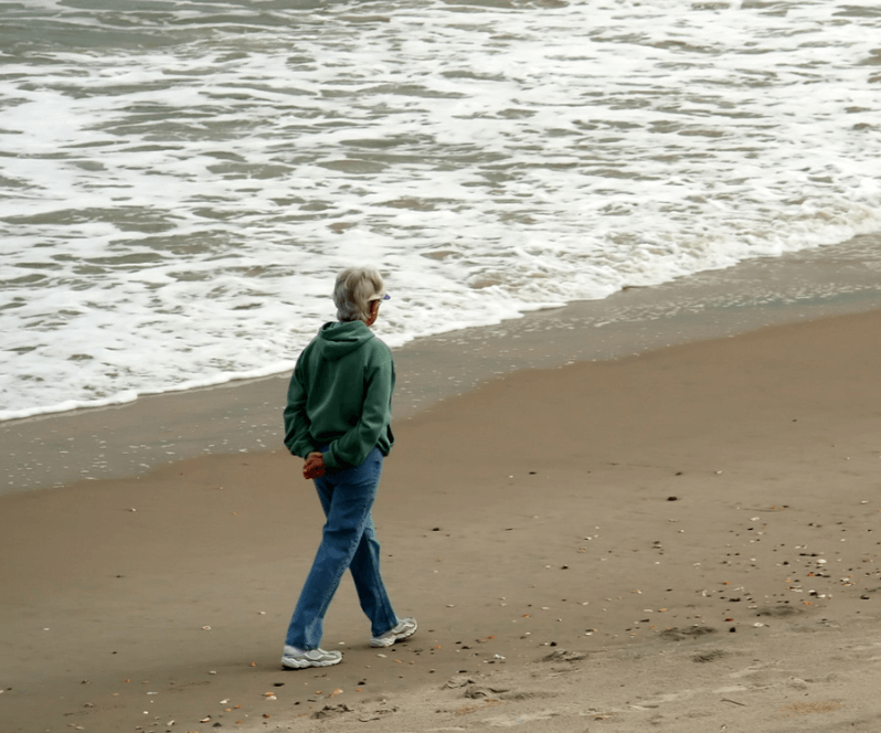 Spinal Cord Stimulation patient Mariette walking on the beach.