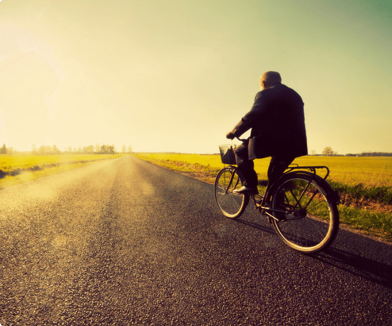 Spinal Cord Stimulation patient Denis riding a bike.