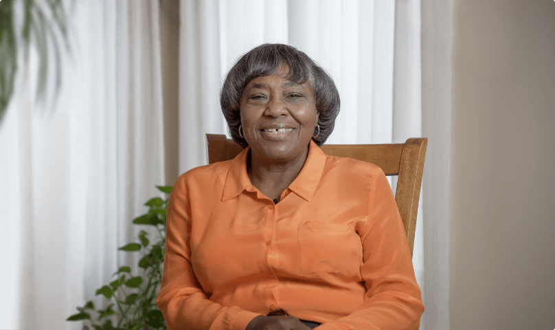 Vertiflex Procedure patient Shirley sitting in a chair smiling.