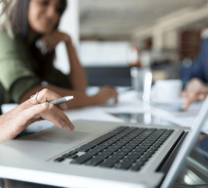 A woman working on a laptop.