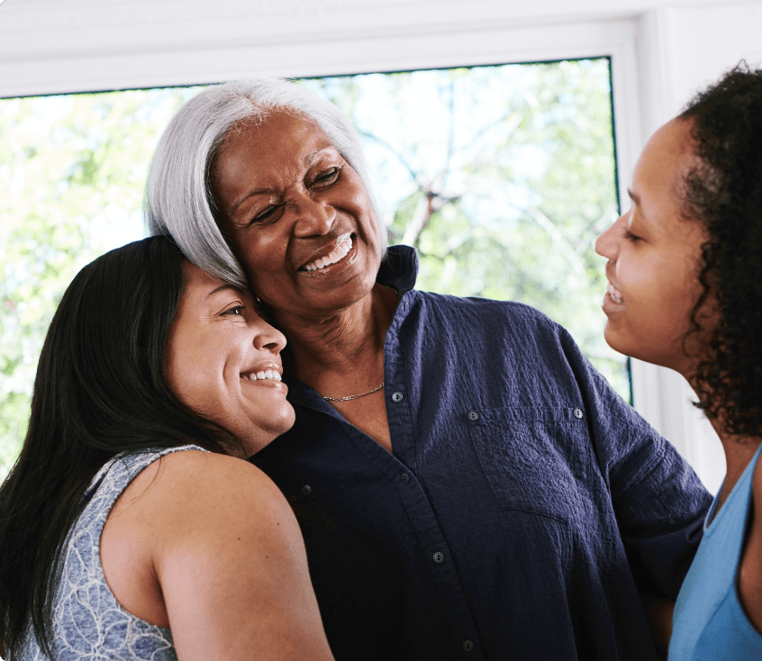 Women hugging family