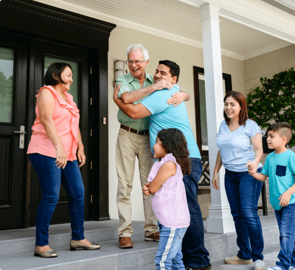 A family gathers together on a front porch.