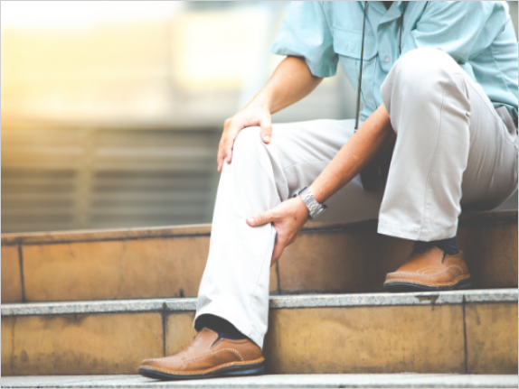 Person holding lower leg in pain.